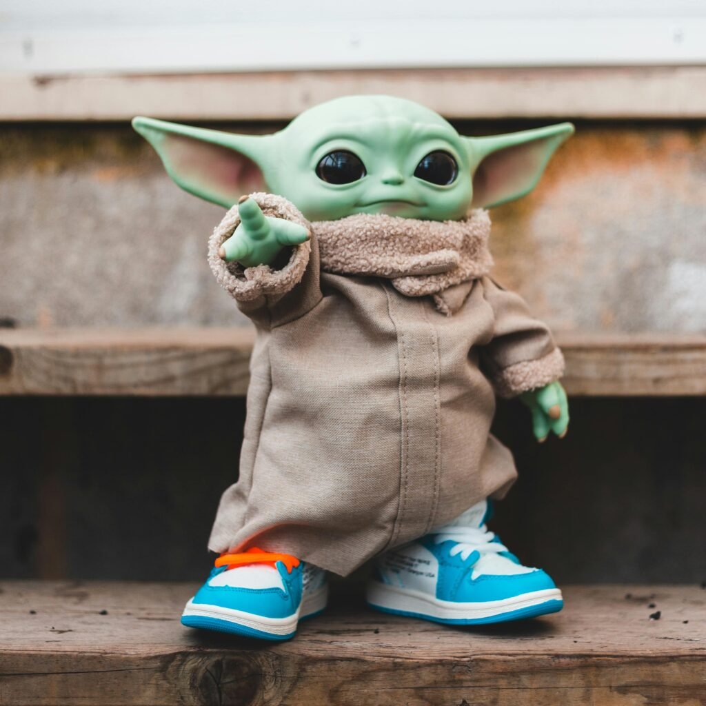 Bright plastic alien character in warm clothes and contemporary luxury sneakers on wooden staircase